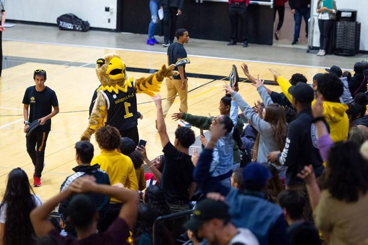 Students attending an exciting basketball game.